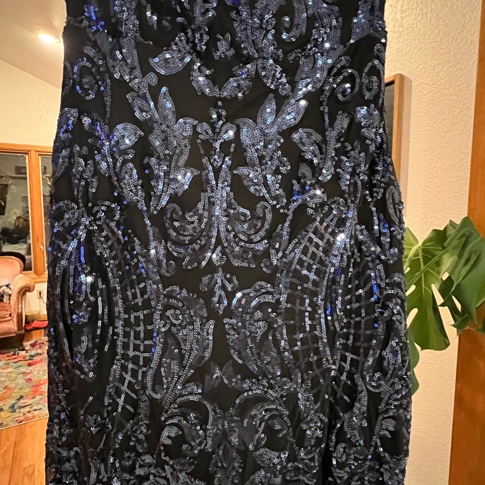 Dark blue sequin gown, slit in the front.